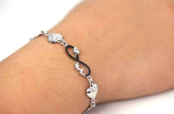 Forever Symbol Sterling Silver Bracelet with Heartbeat and Connected Hearts Design, Featuring Intricate Silver Chain with Multiple Shapes